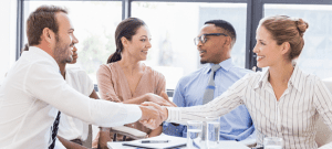 Sales team shaking hands in agreement