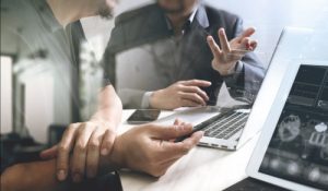 Men reviewing strategy on computer