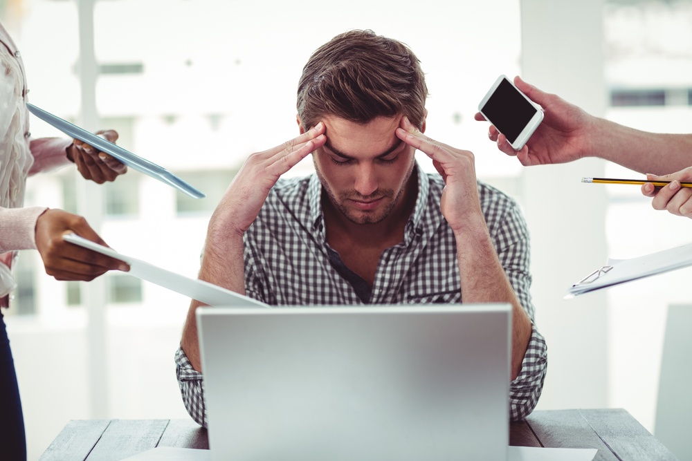 Businessman-stressed-out-at-work-in-casual-office-1 - Is Your Team Joined at the Hip, or Disjointed?