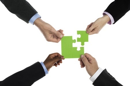 Teamwork_-_4_arms_connecting_puzzle_pieces-1-1 - Hiring Best-Fit Salespeople, Without Having a Fit